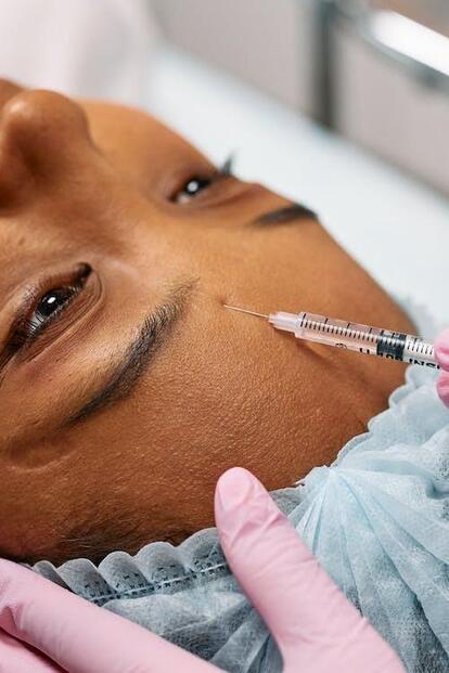 Patient receiving cosmetic care by injections